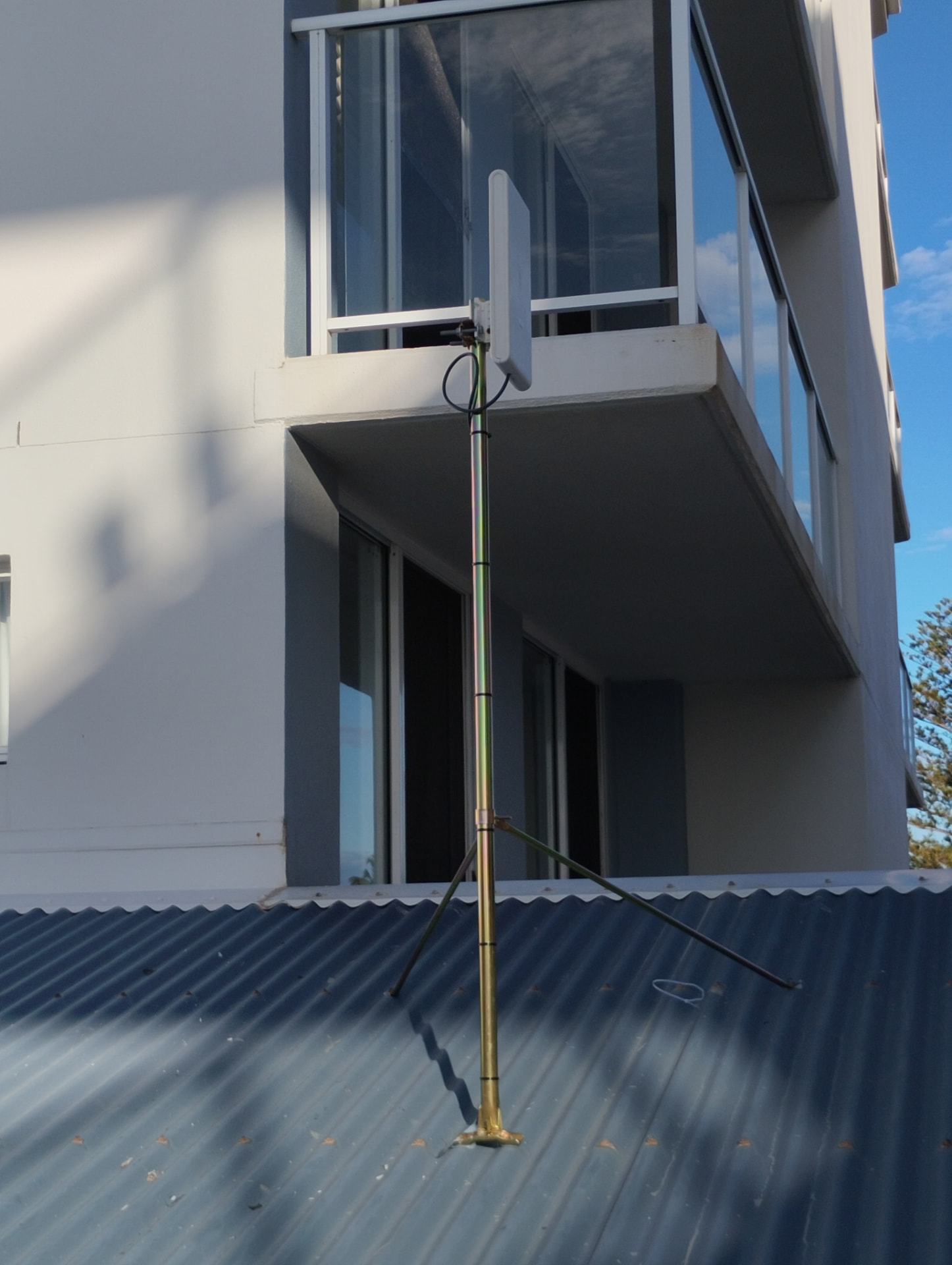 Wireless panel antenna on a guyed mast